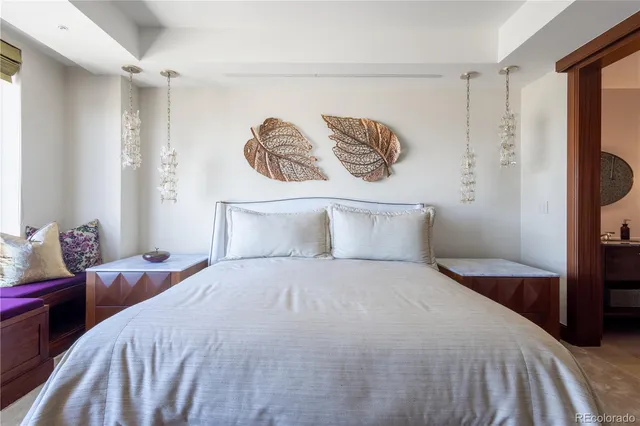 a bedroom with a bed and a painting on the wall