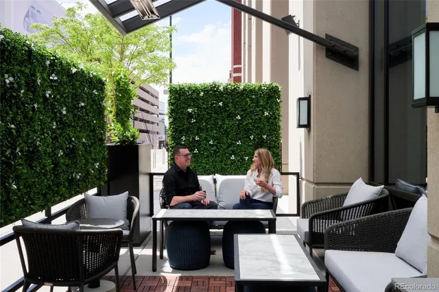 a view of patio with couches and a fire pit