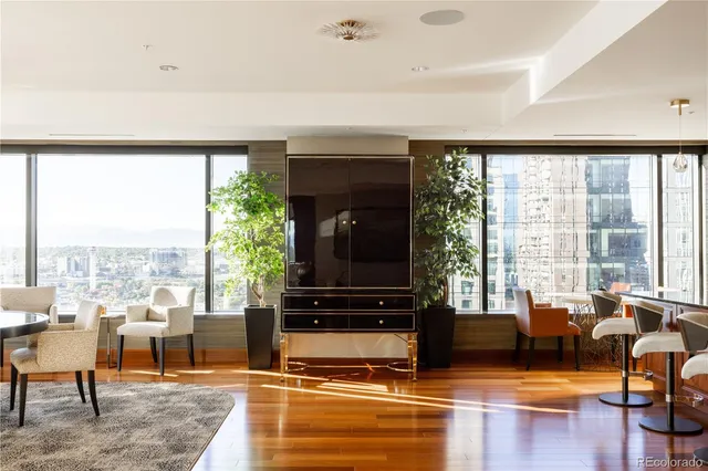 a living room with furniture and a floor to ceiling window