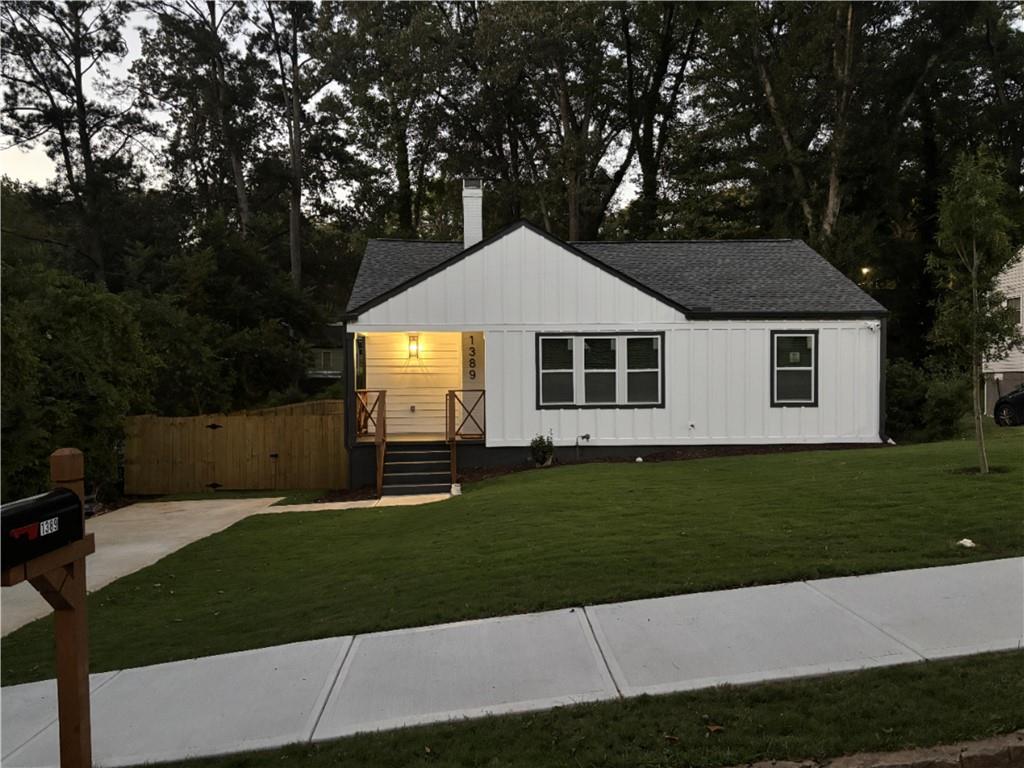 a front view of a house with a garden