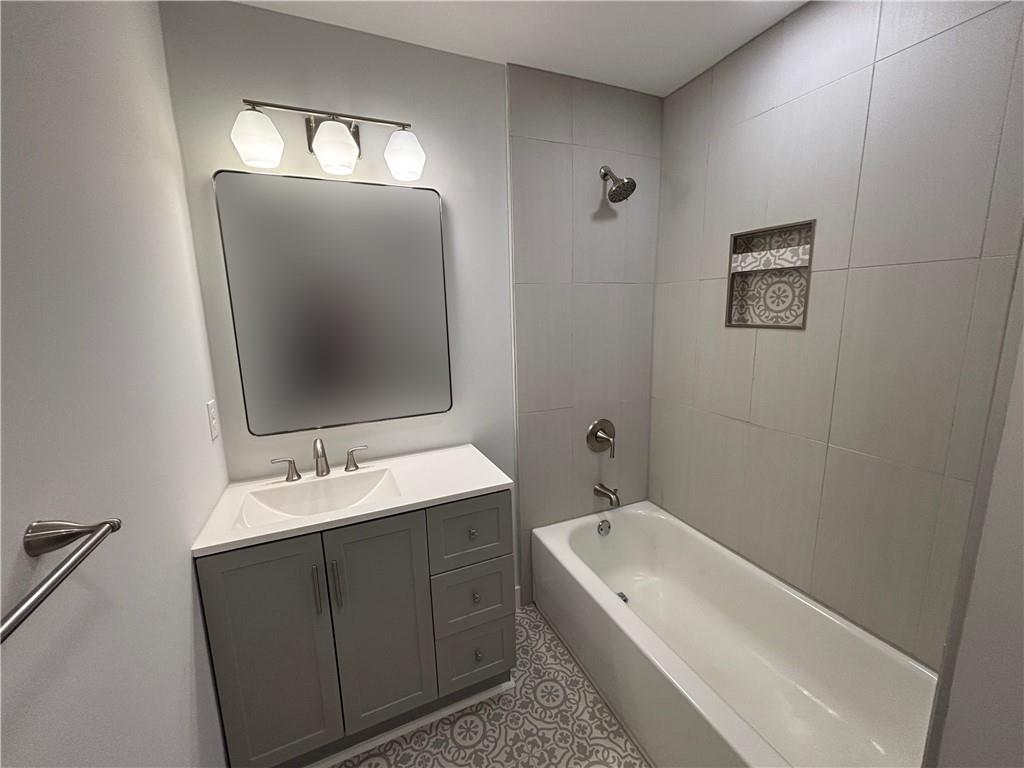 1389 Lanvale Drive Southwest Atlanta, GA 30310 - Photo 17 of 27 a bathroom with a tub sink and mirror