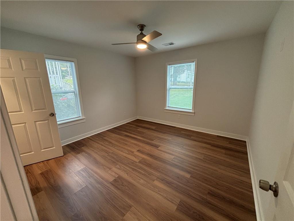 1389 Lanvale Drive Southwest Atlanta, GA 30310 - Photo 18 of 27 a view of an empty room with wooden floor and a window