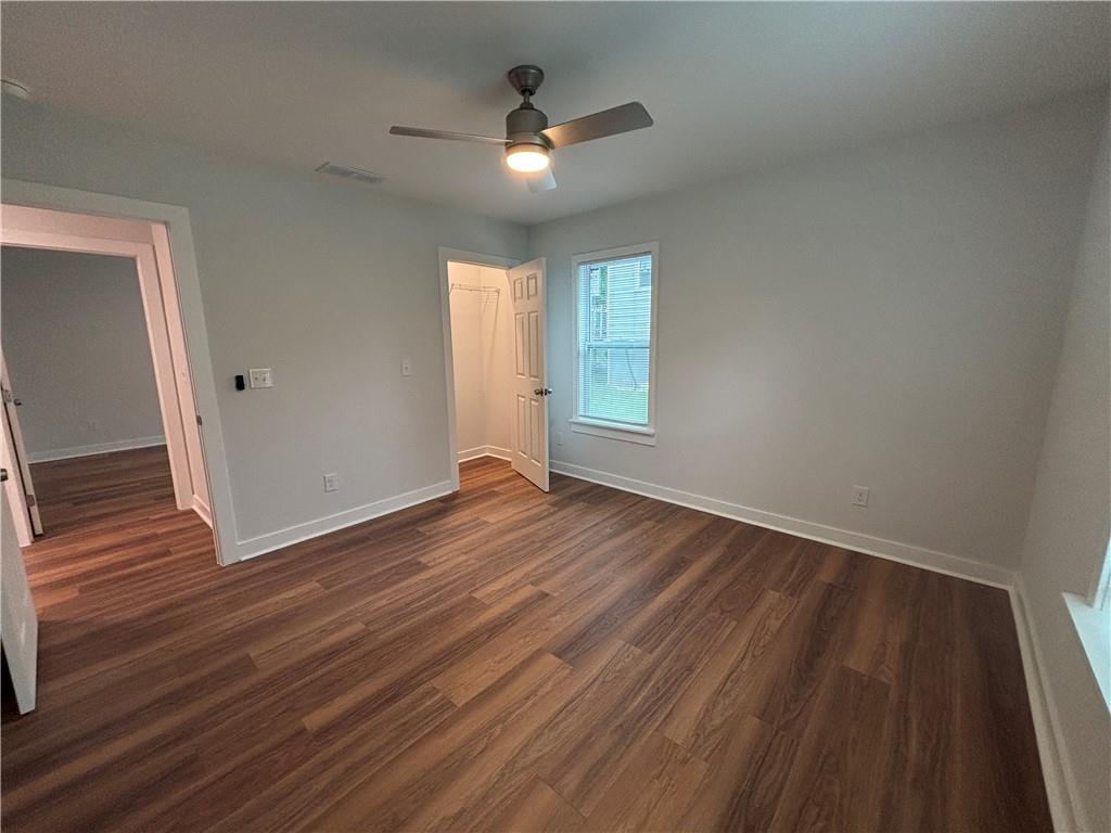 1389 Lanvale Drive Southwest Atlanta, GA 30310 - Photo 19 of 27 an empty room with wooden floor and windows