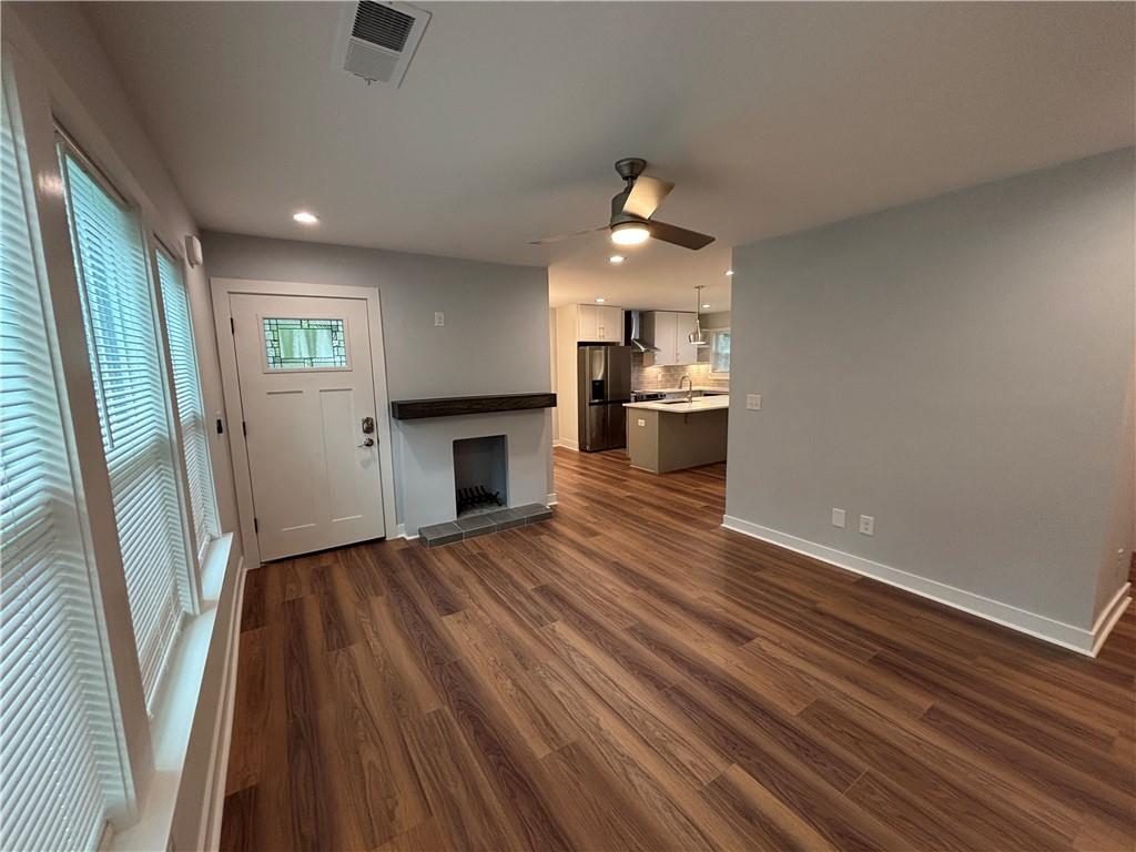 1389 Lanvale Drive Southwest Atlanta, GA 30310 - Photo 3 of 27 a view of empty room with wooden floor and kitchen