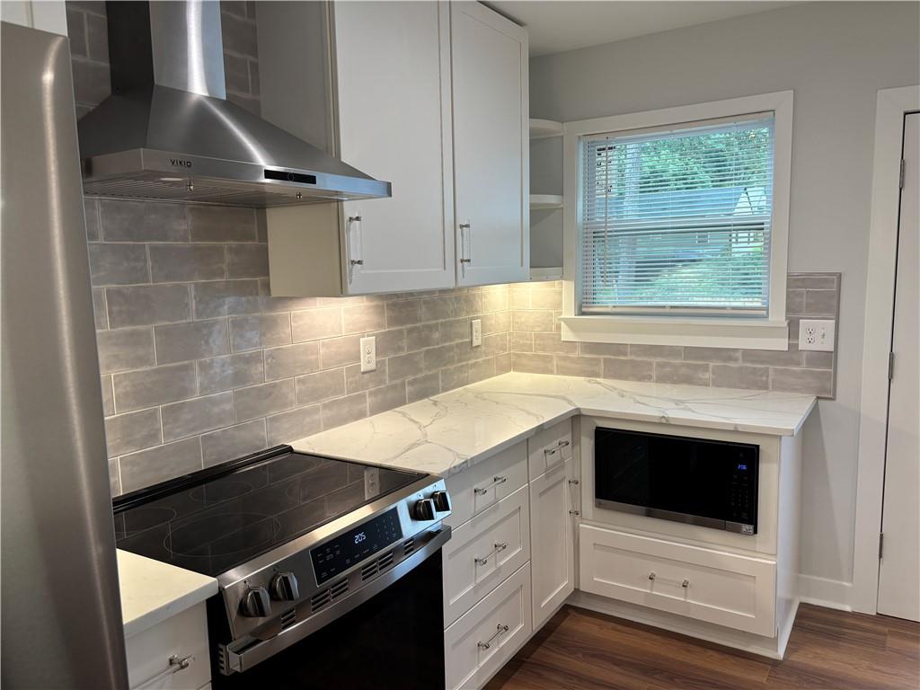 1389 Lanvale Drive Southwest Atlanta, GA 30310 - Photo 9 of 27 a kitchen with granite countertop a stove and a sink