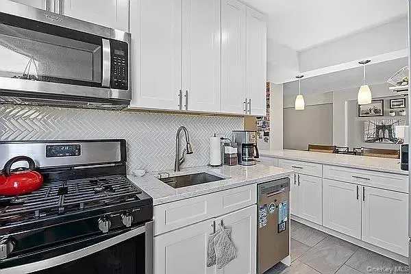 a kitchen with appliances a sink and cabinets