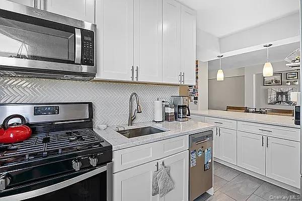 800 Grand Bronx, NY 10451 - Photo 5 of 10 a kitchen with appliances a sink and cabinets