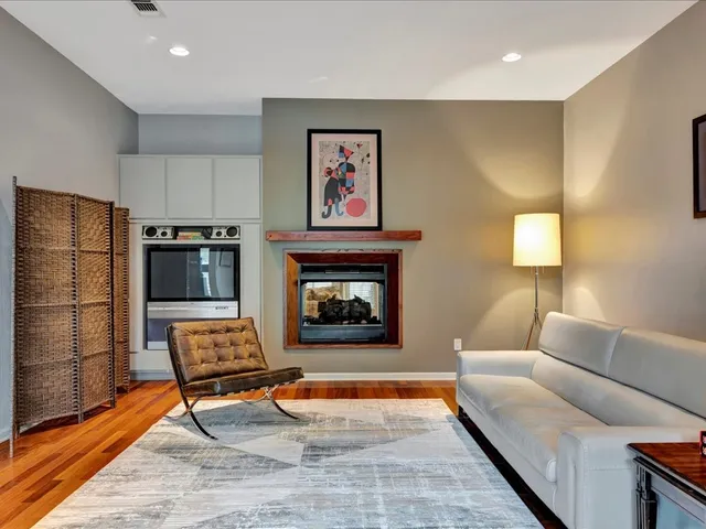 a living room with furniture a rug and a fireplace