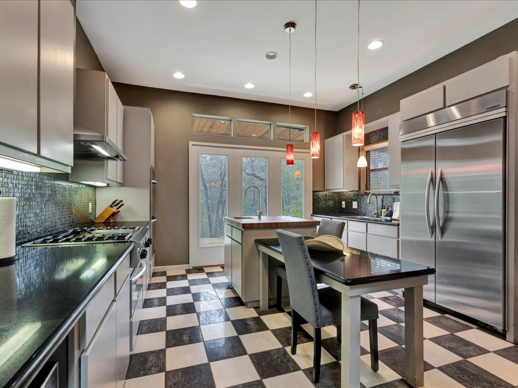 3418 St George Circle Nacogdoches, TX 75965 - Photo 21 of 50 a kitchen with granite countertop stainless steel appliances a sink and a refrigerator