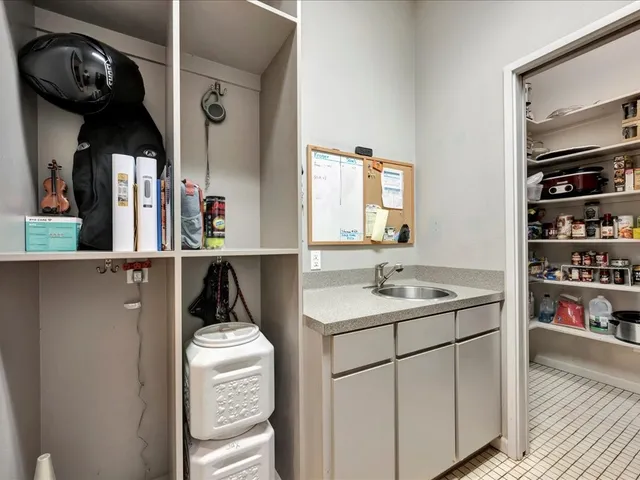 a kitchen with a sink a stove and cabinets