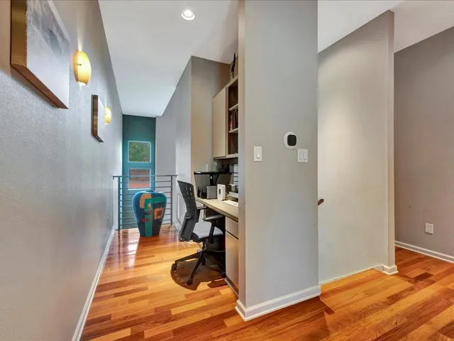a room with wooden floor and furniture