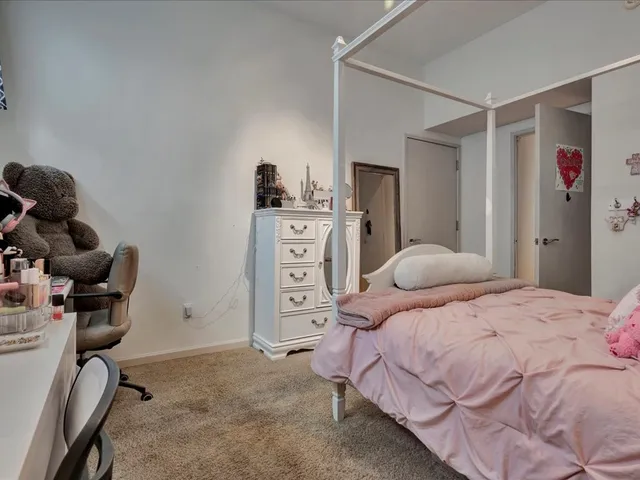 a bedroom with a bed and cabinets