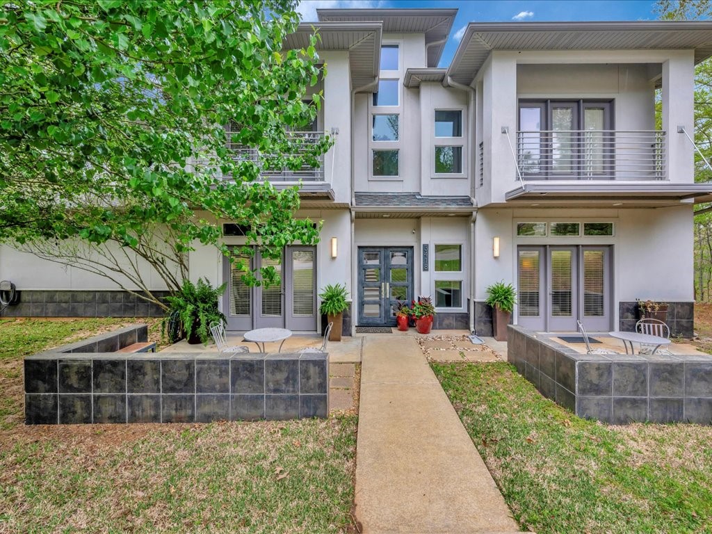 3418 St George Circle Nacogdoches, TX 75965 - Photo 5 of 50 a view of a brick building with a large window and plants