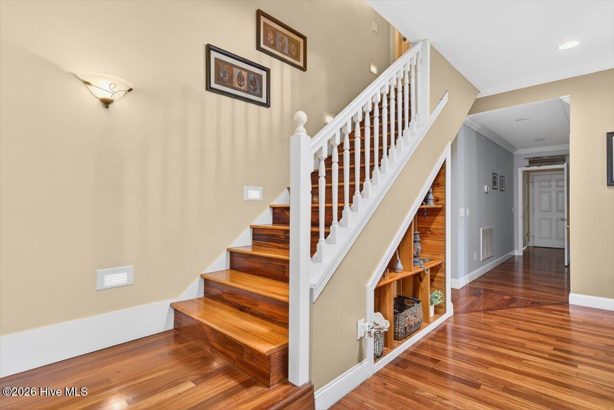 18 Brierwood Road Southwest Shallotte, NC 28470 - Photo 14 of 70 Elegant staircase and foyer with high ceilings and beautiful wood flooring creating a grand first impression.