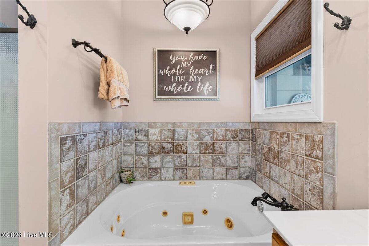 18 Brierwood Road Southwest Shallotte, NC 28470 - Photo 26 of 70 Relaxing soaking tub with tile surround—perfect for unwinding after a long day.