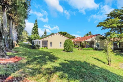 a view of a house with yard and tree s