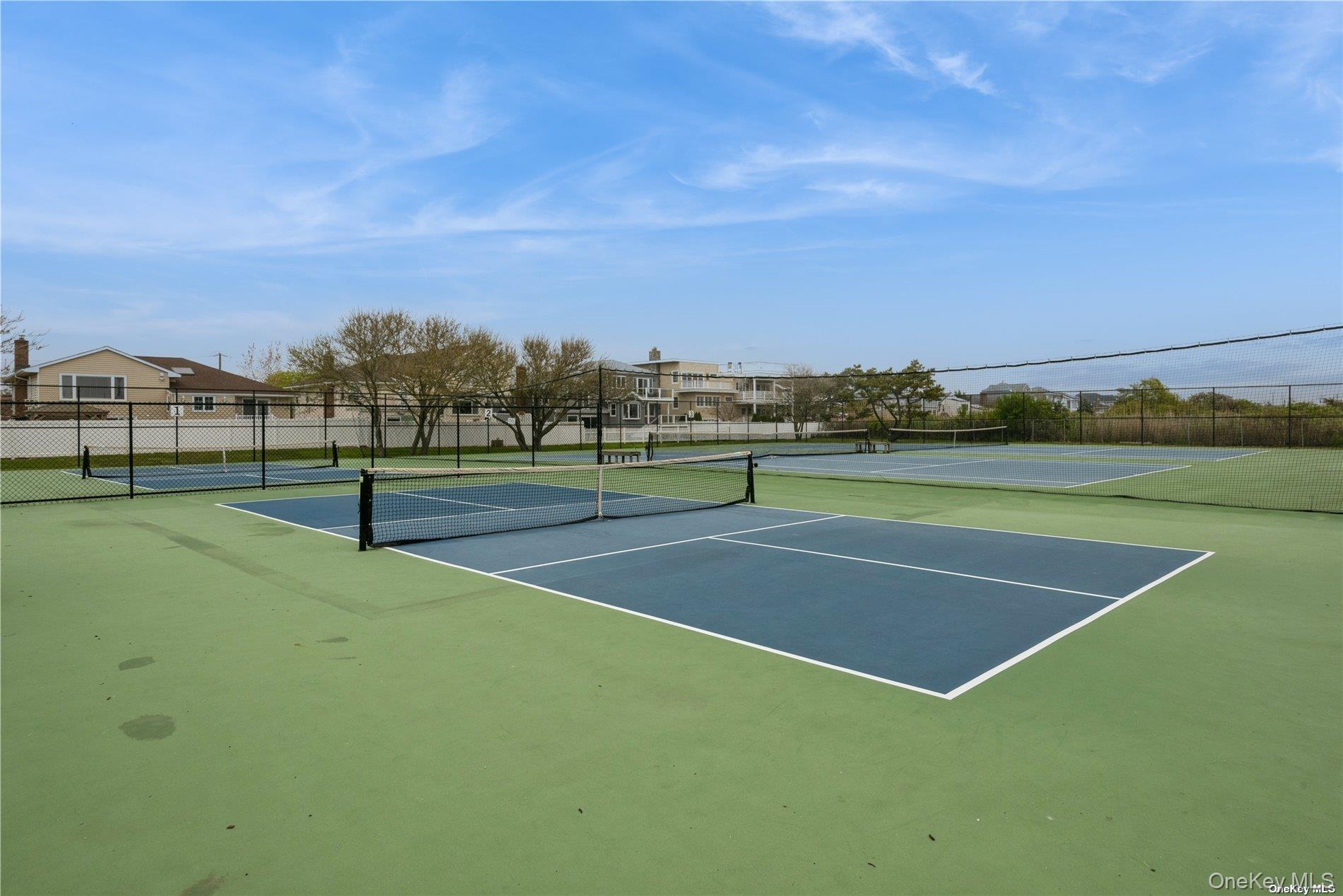 2 Richmond Road, Unit 1H Lido Beach, NY 11561 - Photo 8 of 16 View of tennis court with community basketball court and a residential view