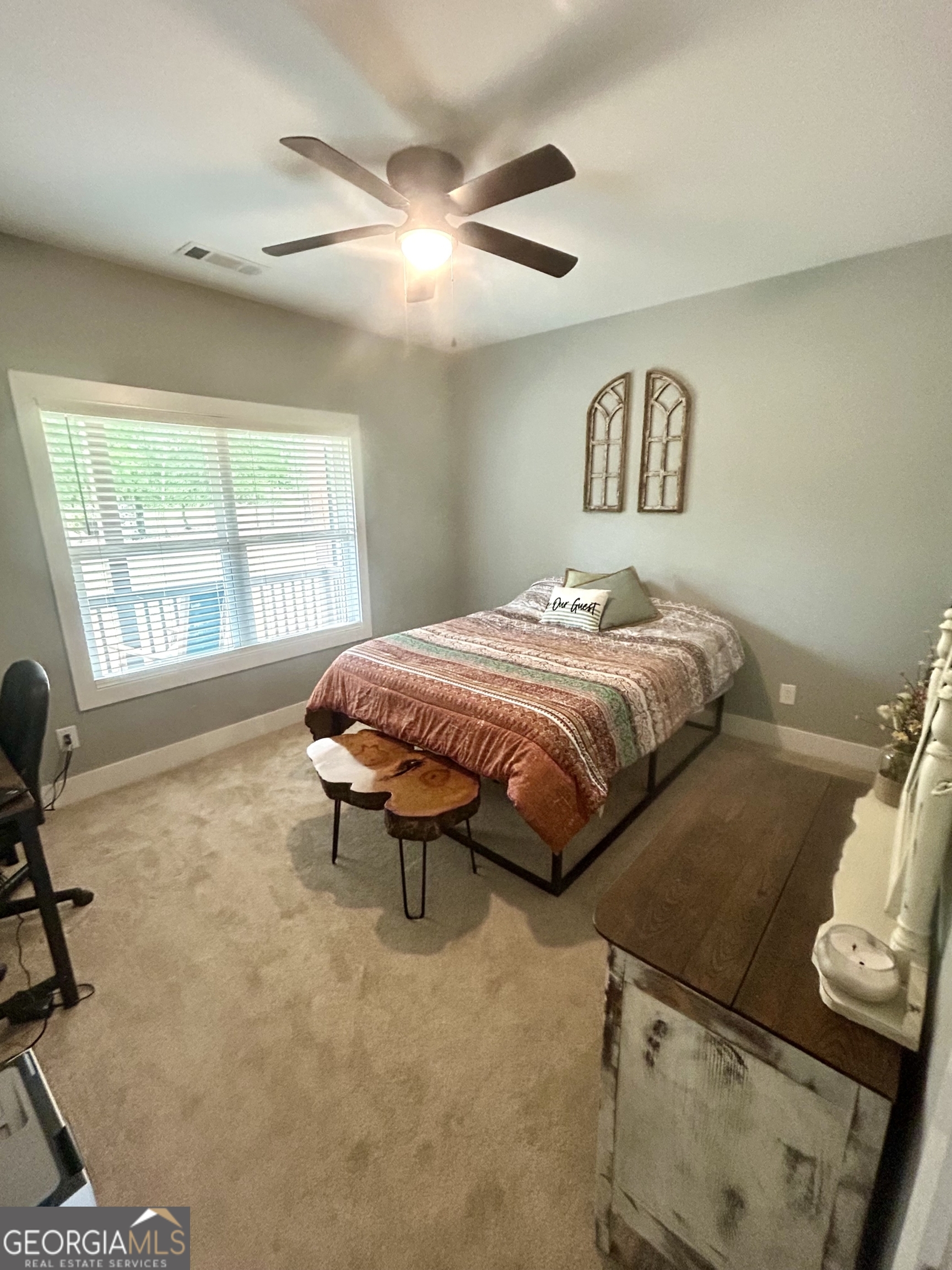 1250 Godfrey Road Madison, GA 30650 - Photo 28 of 42 a bedroom with a bed and a table in it
