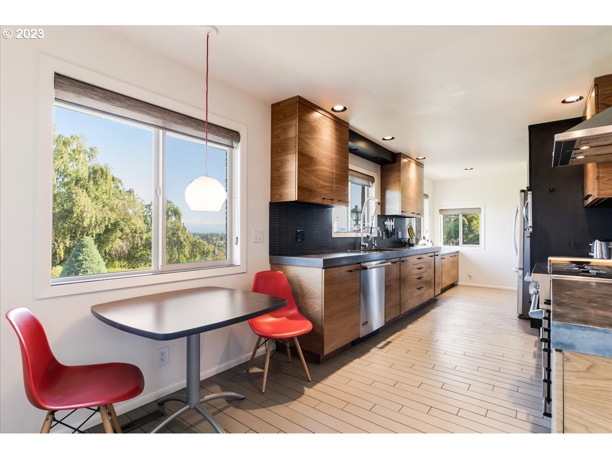 715 Southwest Walters Drive Gresham, OR 97080 - Photo 15 of 48 a kitchen with a dining table chairs and a microwave