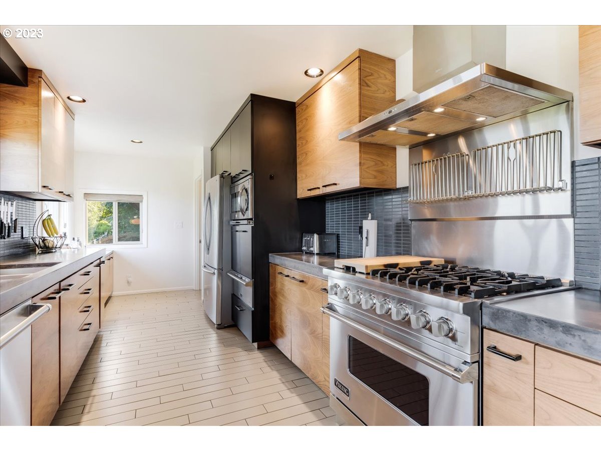 715 Southwest Walters Drive Gresham, OR 97080 - Photo 16 of 48 a kitchen with stainless steel appliances granite countertop a stove a sink dishwasher and a refrigerator