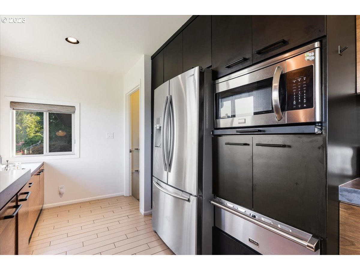715 Southwest Walters Drive Gresham, OR 97080 - Photo 17 of 48 a kitchen with stainless steel appliances wooden cabinets and a refrigerator