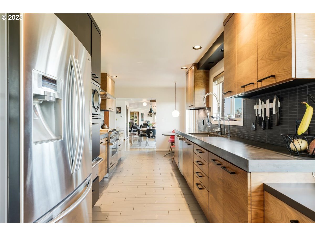 715 Southwest Walters Drive Gresham, OR 97080 - Photo 20 of 48 a kitchen with stainless steel appliances granite countertop a refrigerator a sink and a stove