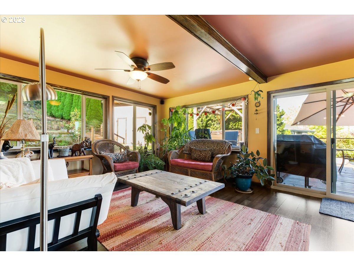 715 Southwest Walters Drive Gresham, OR 97080 - Photo 24 of 48 a living room with furniture a flat screen tv and a floor to ceiling window