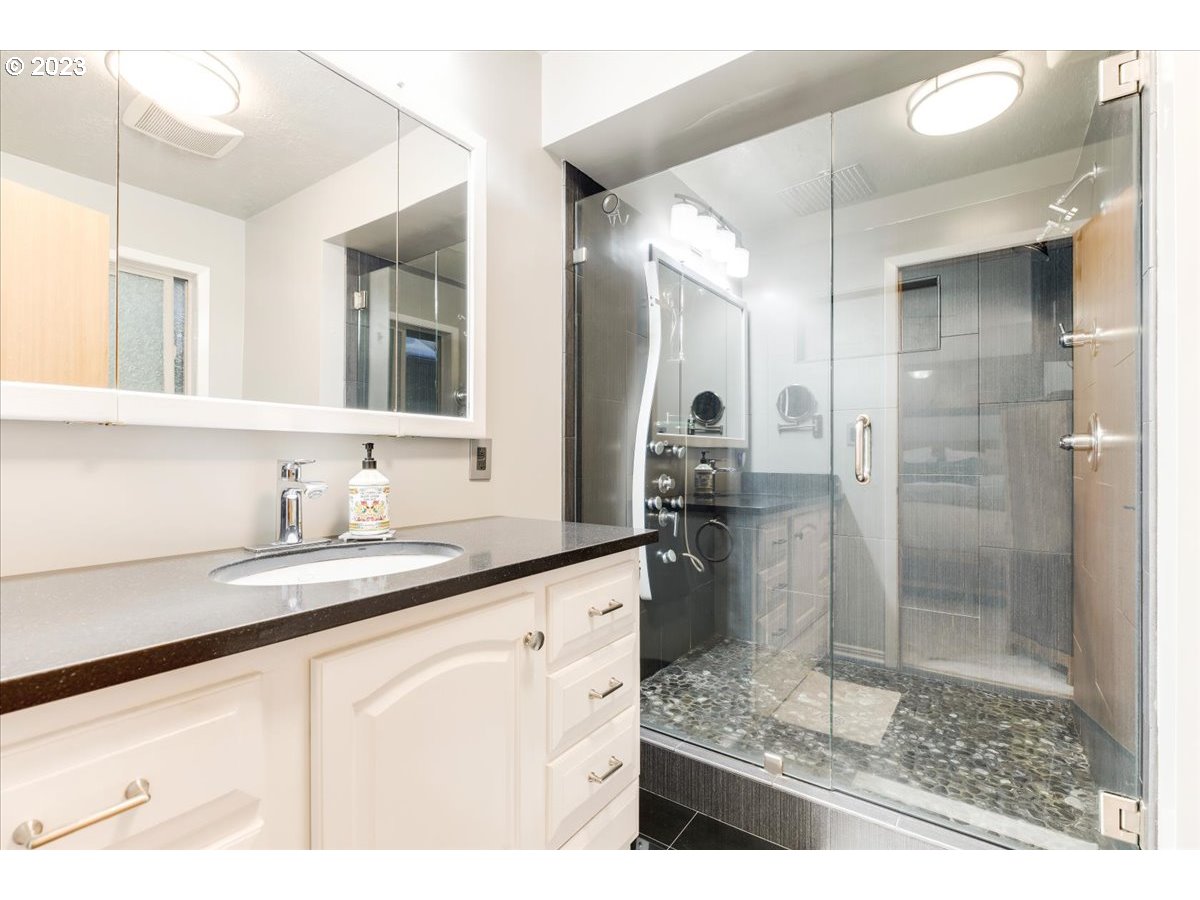 715 Southwest Walters Drive Gresham, OR 97080 - Photo 27 of 48 a bathroom with a granite countertop sink mirror and shower