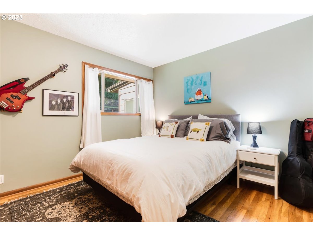 715 Southwest Walters Drive Gresham, OR 97080 - Photo 30 of 48 a bedroom with a bed and a wooden floor