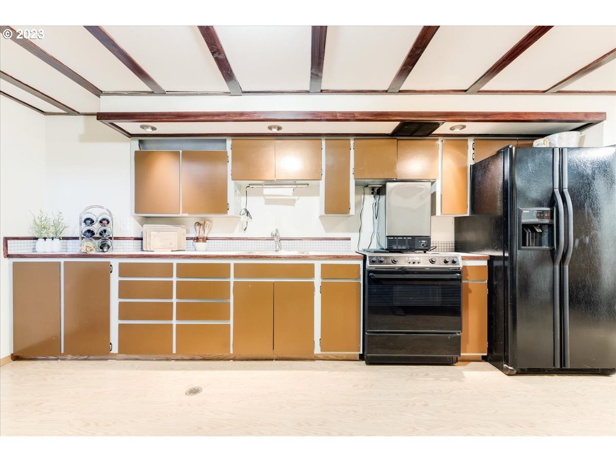 715 Southwest Walters Drive Gresham, OR 97080 - Photo 31 of 48 a kitchen with stainless steel appliances kitchen island granite countertop a refrigerator and a sink