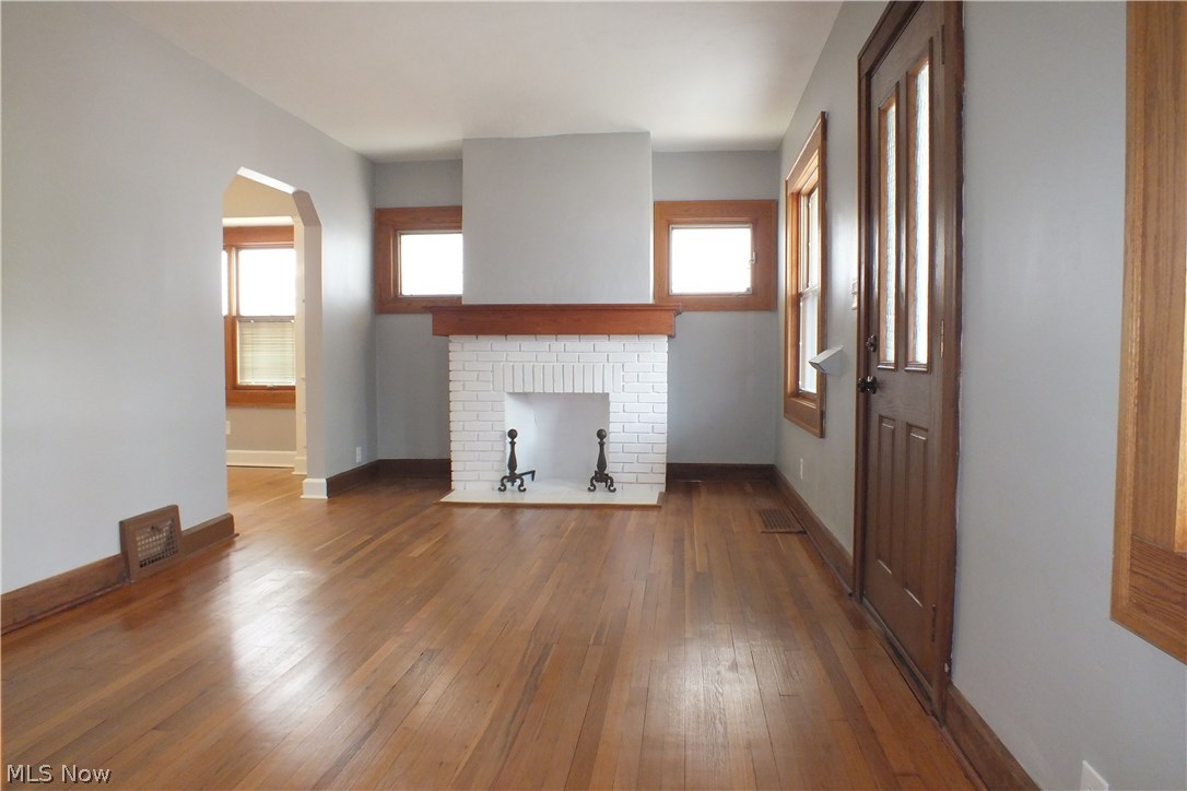 22651 Seabrooke Avenue Euclid, OH 44123 - Photo 6 of 31 Gorgeous light-filled living room with rich wood detail, hardwood floor, complete with fireplace