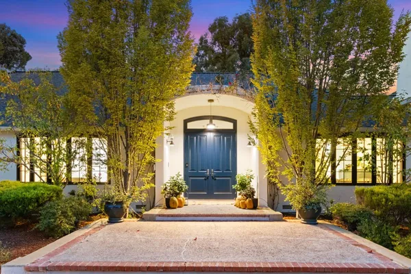 a front view of a house with a garden