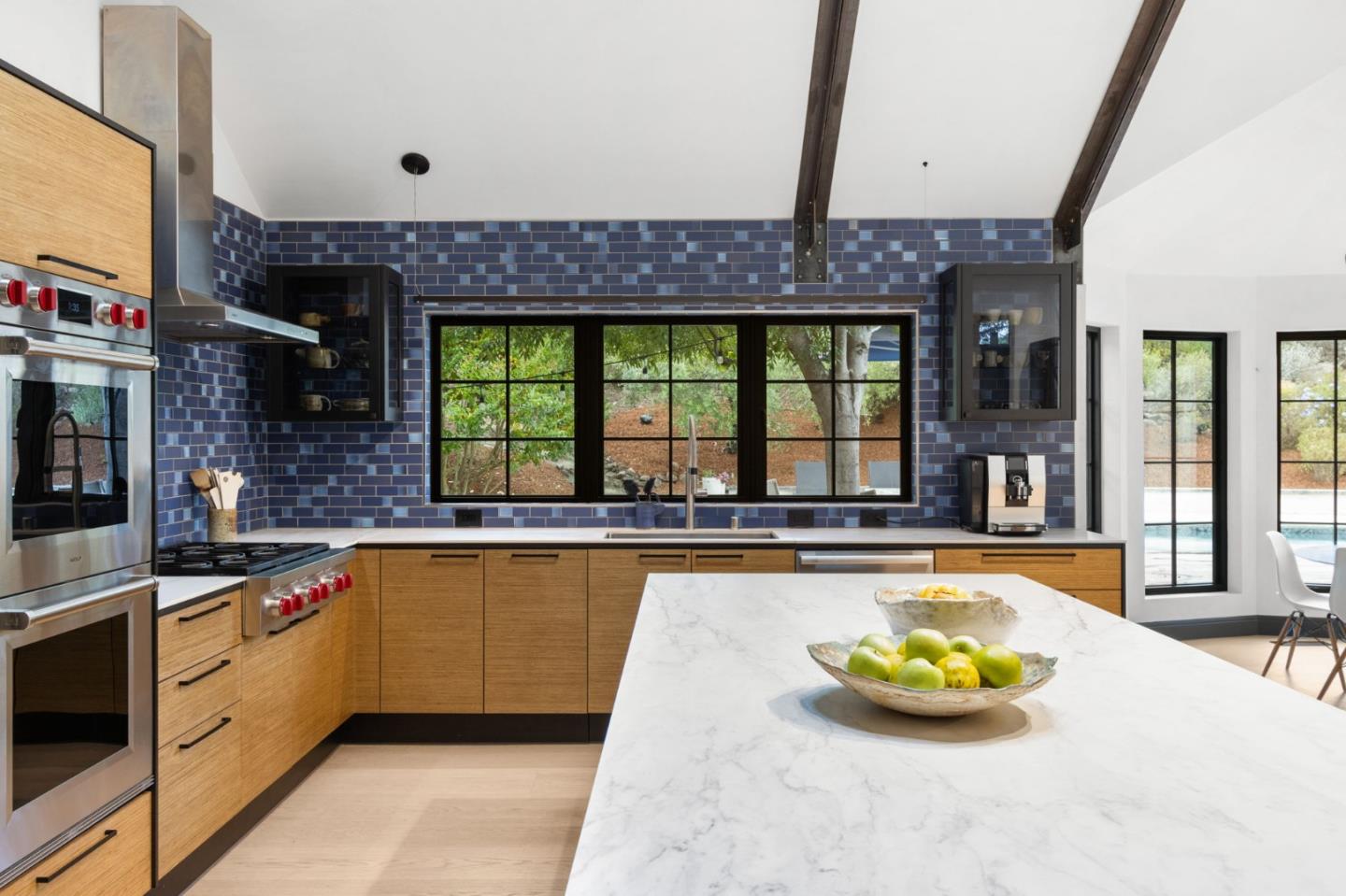 13321 La Paloma Road Los Altos Hills, CA 94022 - Photo 14 of 36 a kitchen with a large window and cabinets
