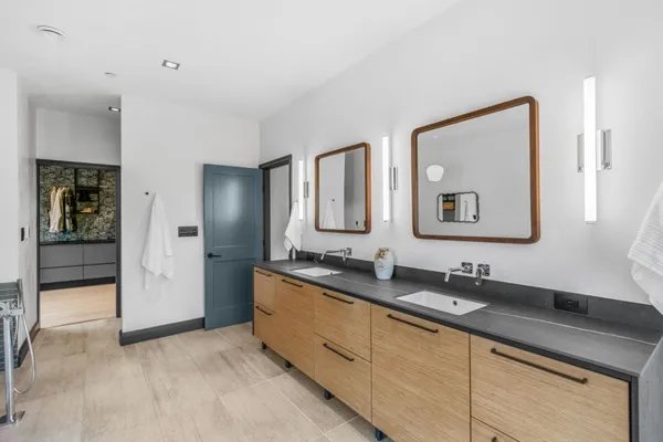 a bathroom with a double vanity sink and mirror