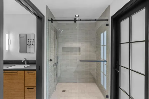 a bathroom with a shower and a sink