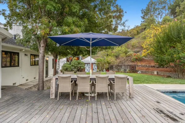 a view of a chair and table on the wooden deck