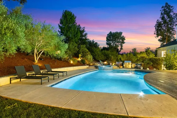 a view of a swimming pool with lounge chair
