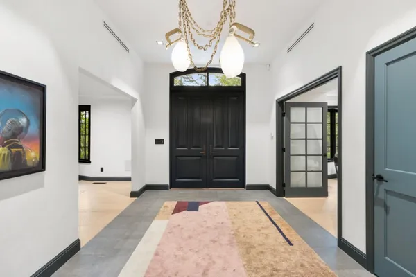 a view of hallway with mirror and door