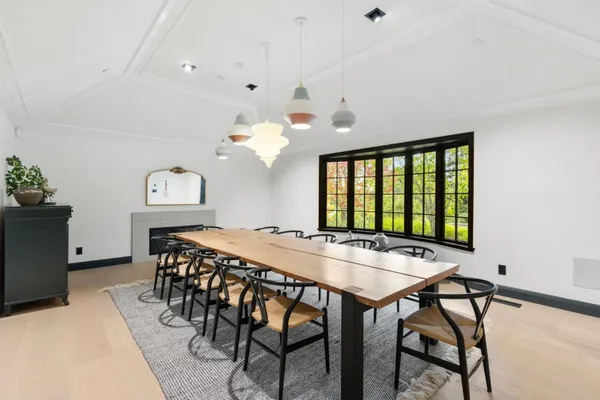 a view of a dining room with furniture and window