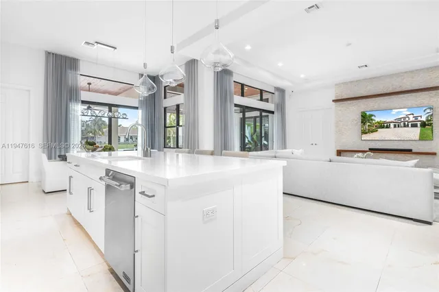 a large white kitchen with a large window