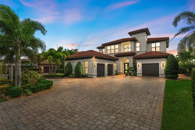 a front view of a house with a garden