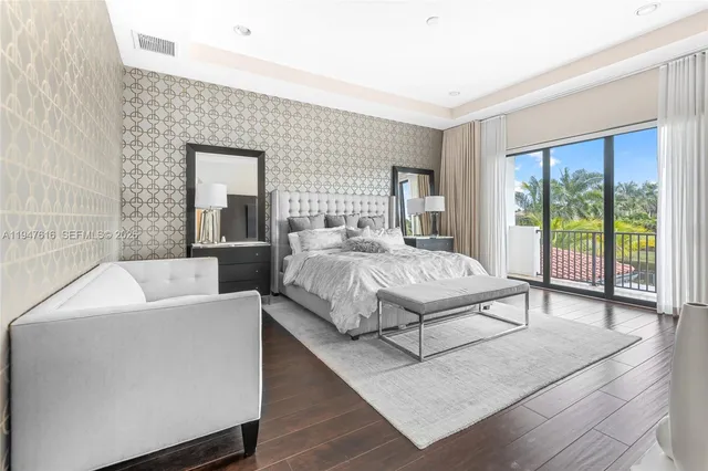 a bedroom with a large bed and a large window