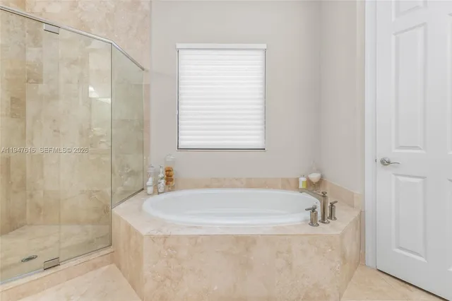 a white bath tub sitting next to a shower