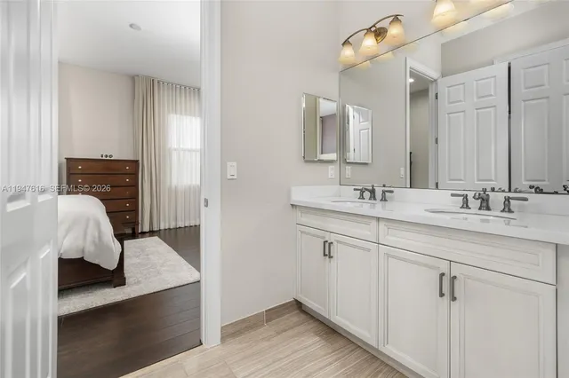 a en suite bathroom with a sink and mirror