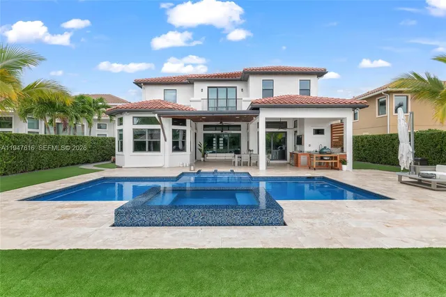 a view of house with a swimming pool and outdoor seating