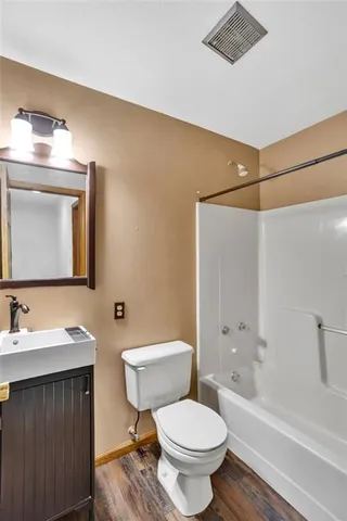 a bathroom with a toilet a sink and bathtub