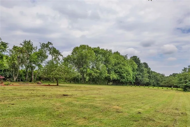 an aerial view of a house with a yard and lake view