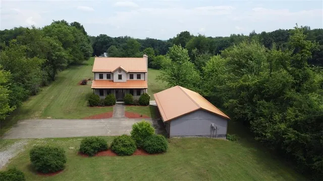 an aerial view of a house with outdoor space swimming pool