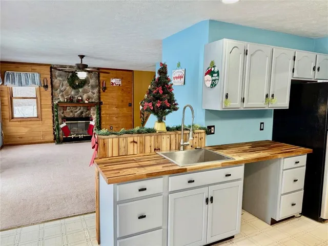a kitchen with granite countertop a sink dishwasher and a stove with white countertops