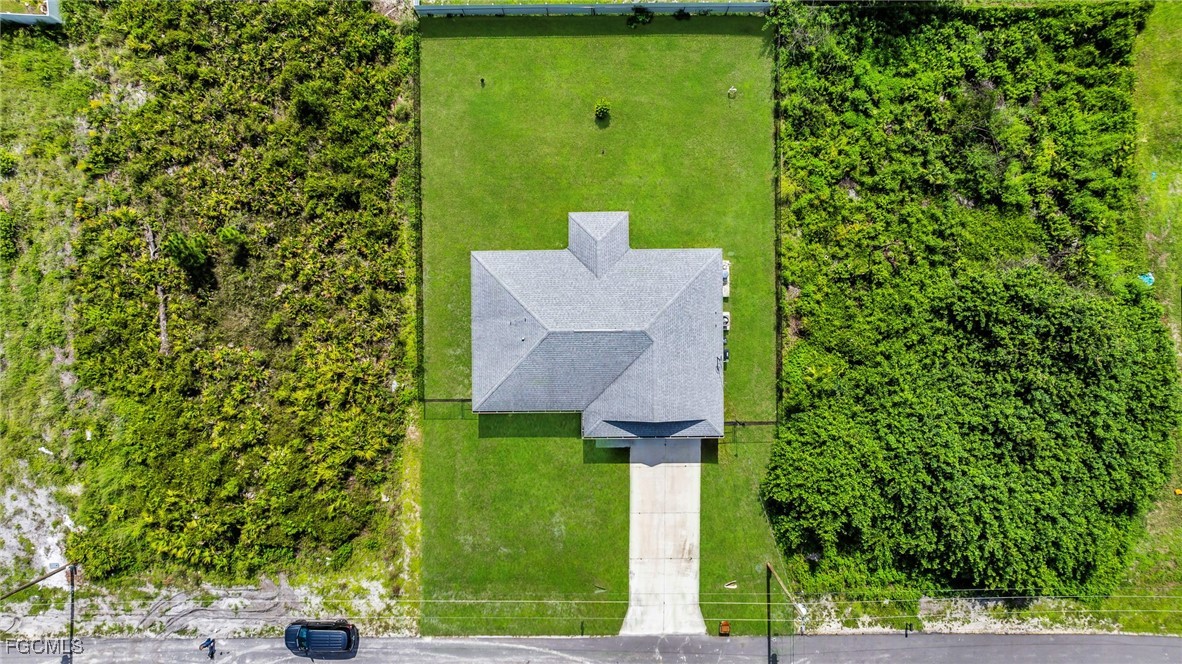 767 Roma Avenue South Lehigh Acres, FL 33974 - Photo 11 of 34 a view of a house with a yard